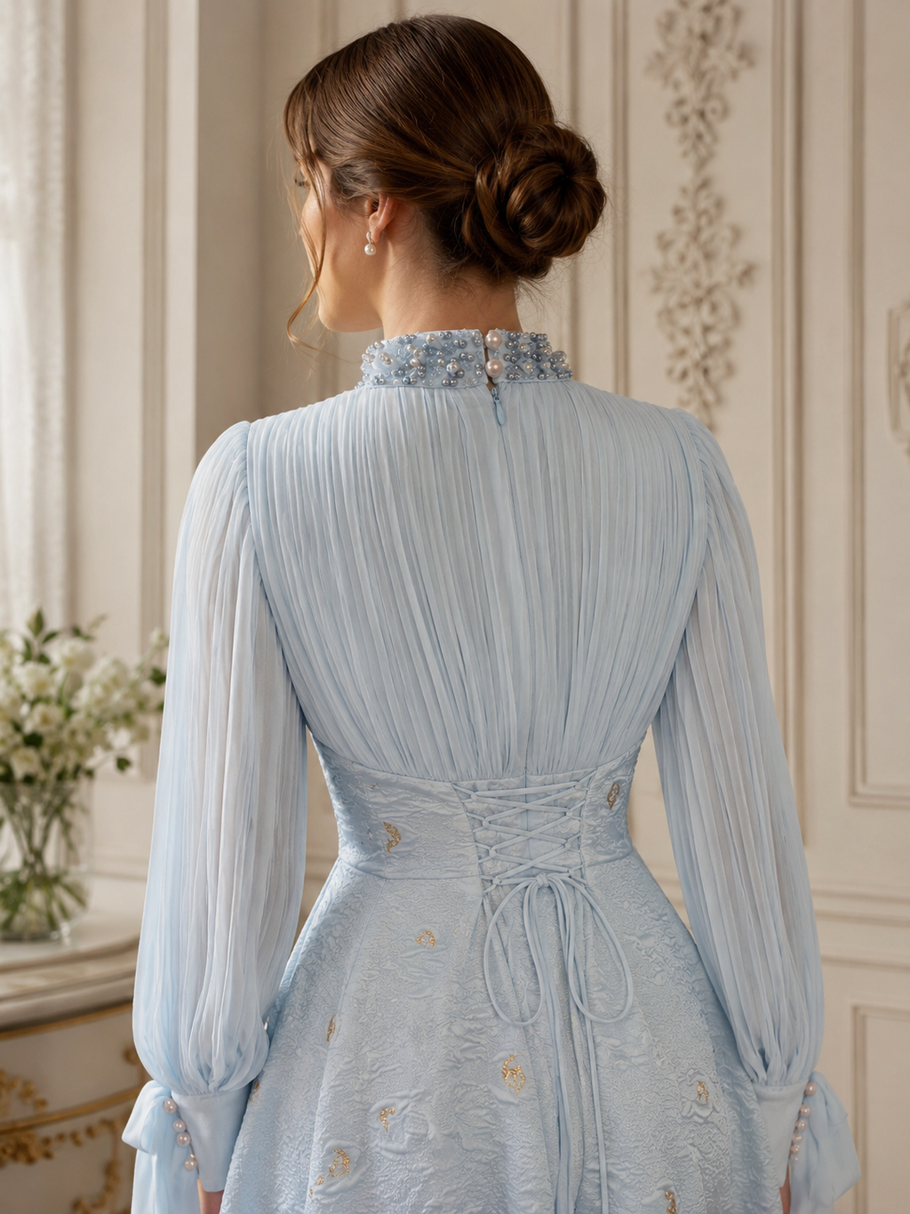 Close-up back detail of ice blue dress showing embellished collar, pearl buttons, pleated chiffon back, and lace-up waist design
